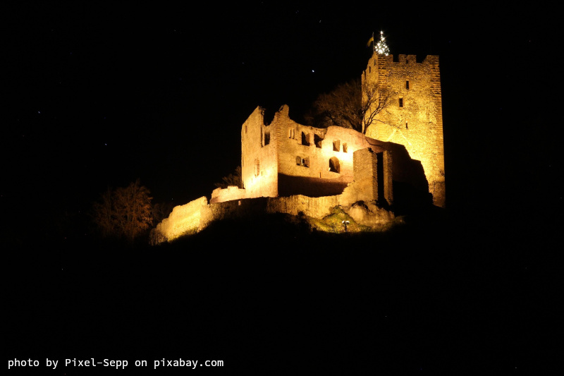 Photo of a castle at night.